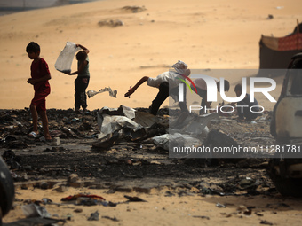 Palestinians are gathering at the site of an Israeli strike on a camp for internally displaced people in Rafah, on May 27, 2024, amid ongoin...