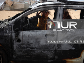 Palestinians are gathering at the site of an Israeli strike on a camp for internally displaced people in Rafah, on May 27, 2024, amid ongoin...