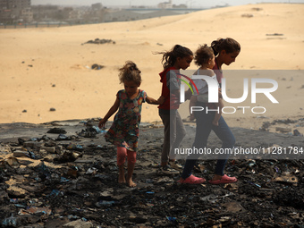 Palestinians are gathering at the site of an Israeli strike on a camp for internally displaced people in Rafah, on May 27, 2024, amid ongoin...