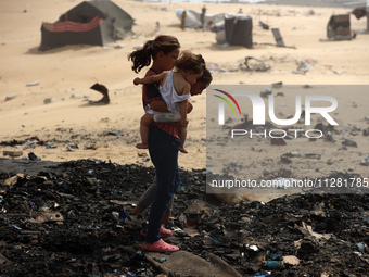 Palestinians are gathering at the site of an Israeli strike on a camp for internally displaced people in Rafah, on May 27, 2024, amid ongoin...