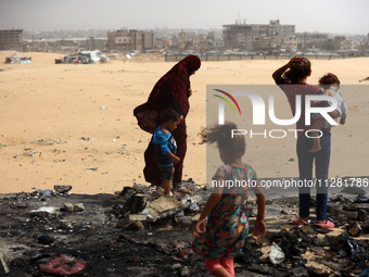 Palestinians are gathering at the site of an Israeli strike on a camp for internally displaced people in Rafah, on May 27, 2024, amid ongoin...