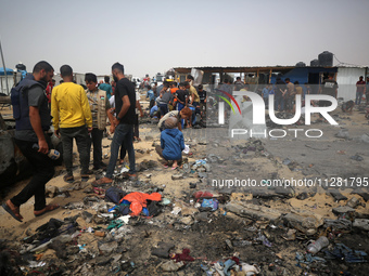 Palestinians are gathering at the site of an Israeli strike on a camp for internally displaced people in Rafah, on May 27, 2024, amid ongoin...