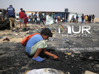 Palestinians are gathering at the site of an Israeli strike on a camp for internally displaced people in Rafah, on May 27, 2024, amid ongoin...