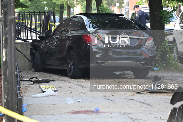 A Mercedes Benz is damaged, and one person is dead after a vehicle collision following a police pursuit in Brooklyn, New York, on May 26, 20...