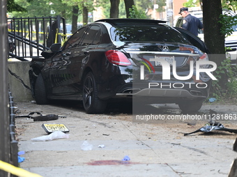 A Mercedes Benz is damaged, and one person is dead after a vehicle collision following a police pursuit in Brooklyn, New York, on May 26, 20...