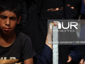 Palestinians are gathering at the site of an Israeli strike on a camp for internally displaced people in Rafah, on May 27, 2024, amid ongoin...