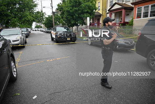 Police are guarding the crime scene. A 26-year-old male victim is suffering gunshot wound injuries in a shooting in Paterson, New Jersey, Un...