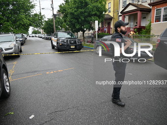 Police are guarding the crime scene. A 26-year-old male victim is suffering gunshot wound injuries in a shooting in Paterson, New Jersey, Un...