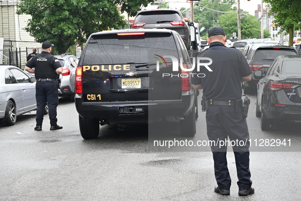 Police are guarding a vehicle with several bullet holes and towing it from the crime scene. A 26-year-old male victim is suffering gunshot w...