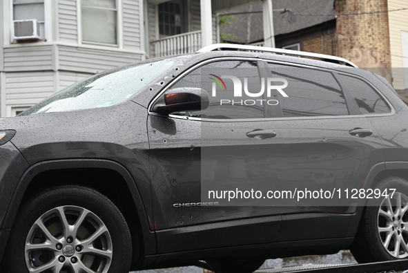 Police are guarding a vehicle with several bullet holes and towing it from the crime scene. A 26-year-old male victim is suffering gunshot w...