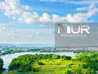 The Shuangguihu Lake National Wetland Park is being seen under the blue sky and white clouds in Chongqing, China, on May 27, 2024. Recently,...