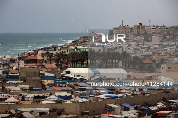 A general view is showing tents housing internally displaced Palestinians crowding the beach and the Mediterranean shoreline in Deir el-Bala...