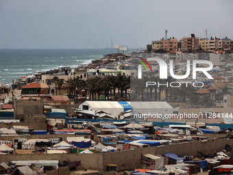 A general view is showing tents housing internally displaced Palestinians crowding the beach and the Mediterranean shoreline in Deir el-Bala...