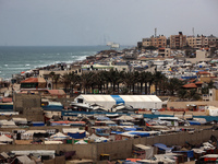 A general view is showing tents housing internally displaced Palestinians crowding the beach and the Mediterranean shoreline in Deir el-Bala...