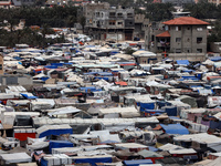 A general view is showing tents housing internally displaced Palestinians crowding the beach and the Mediterranean shoreline in Deir el-Bala...