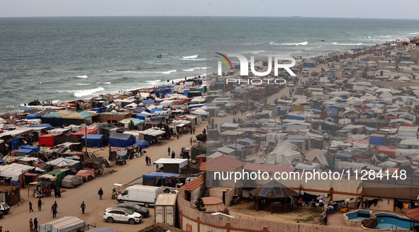 A general view is showing tents housing internally displaced Palestinians crowding the beach and the Mediterranean shoreline in Deir el-Bala...