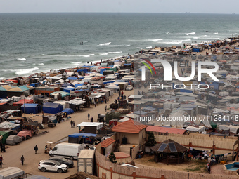 A general view is showing tents housing internally displaced Palestinians crowding the beach and the Mediterranean shoreline in Deir el-Bala...