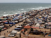 A general view is showing tents housing internally displaced Palestinians crowding the beach and the Mediterranean shoreline in Deir el-Bala...