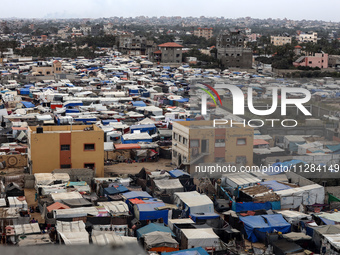 A general view is showing tents housing internally displaced Palestinians crowding the beach and the Mediterranean shoreline in Deir el-Bala...