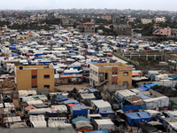 A general view is showing tents housing internally displaced Palestinians crowding the beach and the Mediterranean shoreline in Deir el-Bala...