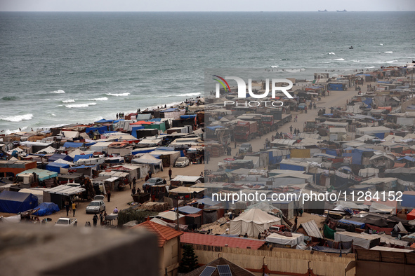 A general view is showing tents housing internally displaced Palestinians crowding the beach and the Mediterranean shoreline in Deir el-Bala...