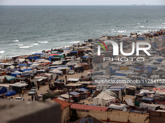 A general view is showing tents housing internally displaced Palestinians crowding the beach and the Mediterranean shoreline in Deir el-Bala...