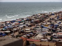 A general view is showing tents housing internally displaced Palestinians crowding the beach and the Mediterranean shoreline in Deir el-Bala...