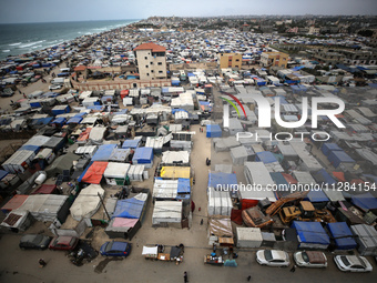 A general view is showing tents housing internally displaced Palestinians crowding the beach and the Mediterranean shoreline in Deir el-Bala...