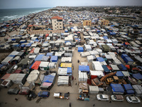 A general view is showing tents housing internally displaced Palestinians crowding the beach and the Mediterranean shoreline in Deir el-Bala...