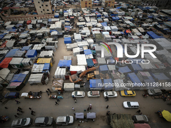 A general view is showing tents housing internally displaced Palestinians crowding the beach and the Mediterranean shoreline in Deir el-Bala...