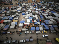 A general view is showing tents housing internally displaced Palestinians crowding the beach and the Mediterranean shoreline in Deir el-Bala...