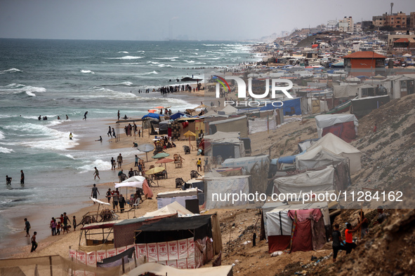 A general view is showing tents housing internally displaced Palestinians crowding the beach and the Mediterranean shoreline in Deir el-Bala...