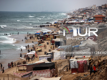 A general view is showing tents housing internally displaced Palestinians crowding the beach and the Mediterranean shoreline in Deir el-Bala...