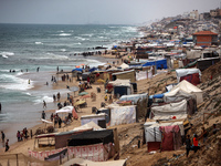 A general view is showing tents housing internally displaced Palestinians crowding the beach and the Mediterranean shoreline in Deir el-Bala...