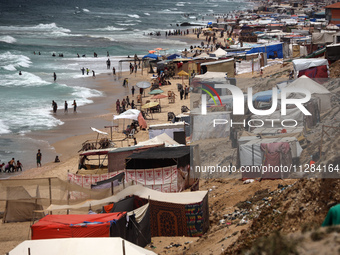 A general view is showing tents housing internally displaced Palestinians crowding the beach and the Mediterranean shoreline in Deir el-Bala...