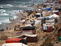 A general view is showing tents housing internally displaced Palestinians crowding the beach and the Mediterranean shoreline in Deir el-Bala...