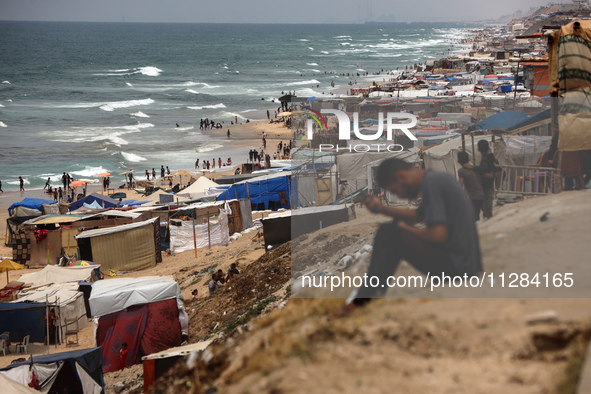 A general view is showing tents housing internally displaced Palestinians crowding the beach and the Mediterranean shoreline in Deir el-Bala...