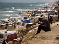 A general view is showing tents housing internally displaced Palestinians crowding the beach and the Mediterranean shoreline in Deir el-Bala...