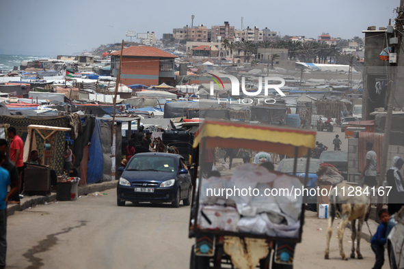 A general view is showing tents housing internally displaced Palestinians crowding the beach and the Mediterranean shoreline in Deir el-Bala...