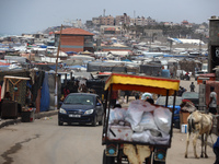 A general view is showing tents housing internally displaced Palestinians crowding the beach and the Mediterranean shoreline in Deir el-Bala...