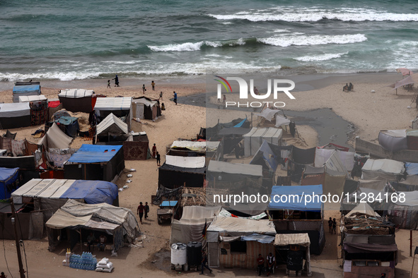 A general view is showing tents housing internally displaced Palestinians crowding the beach and the Mediterranean shoreline in Deir el-Bala...