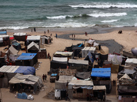 A general view is showing tents housing internally displaced Palestinians crowding the beach and the Mediterranean shoreline in Deir el-Bala...