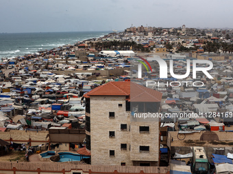 A general view is showing tents housing internally displaced Palestinians crowding the beach and the Mediterranean shoreline in Deir el-Bala...