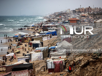 A general view is showing tents housing internally displaced Palestinians crowding the beach and the Mediterranean shoreline in Deir el-Bala...