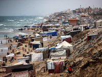 A general view is showing tents housing internally displaced Palestinians crowding the beach and the Mediterranean shoreline in Deir el-Bala...