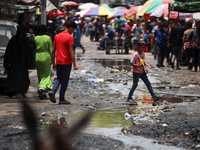 Displaced Palestinians are walking near sewage water in Deir el-Balah in the central Gaza Strip on May 28, 2024, amid the ongoing conflict b...