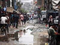 Displaced Palestinians are walking near sewage water in Deir el-Balah in the central Gaza Strip on May 28, 2024, amid the ongoing conflict b...