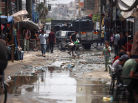 Displaced Palestinians are walking near sewage water in Deir el-Balah in the central Gaza Strip on May 28, 2024, amid the ongoing conflict b...