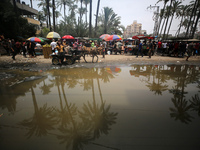 Displaced Palestinians are walking near sewage water in Deir el-Balah in the central Gaza Strip on May 28, 2024, amid the ongoing conflict b...