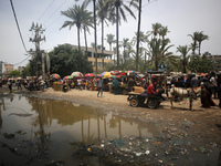 Displaced Palestinians are walking near sewage water in Deir el-Balah in the central Gaza Strip on May 28, 2024, amid the ongoing conflict b...